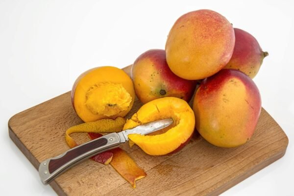 Sliced Fruits on Chopping Board With Knife